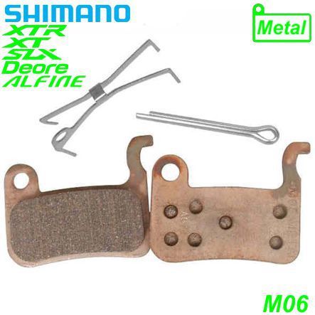Shimano Bremsbeläge M06 Metall mit Feder und Clip Paar Blister